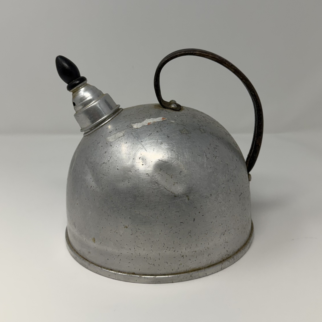 Vintage metal oil can with a black handle on a white background