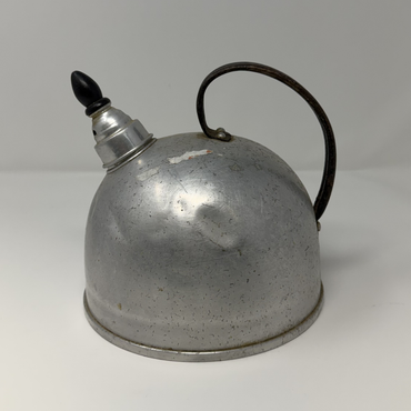 Vintage metal oil can with a black handle on a white background