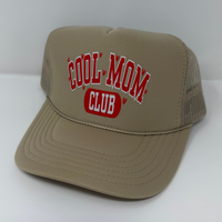 Beige cap with 'Cool Mom Club' text on a white background