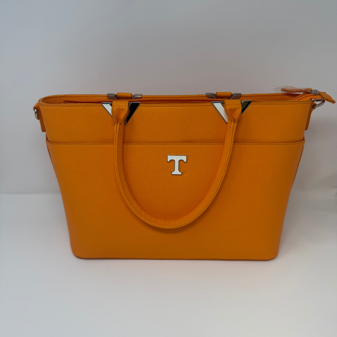 An orange textured leather tote bag with double top handles, a silver 'T' logo on the front, and silver-tone hardware, photographed on a light gray background.